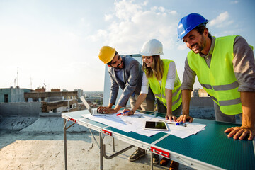 Architects, business manager and engineer meeting project at building site