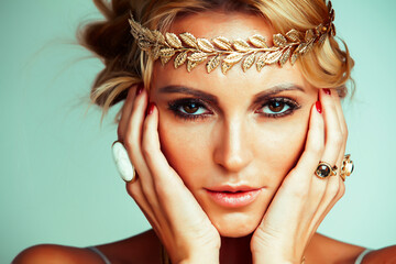 Canvas Print - young blond woman dressed like ancient greek godess, gold jewelry close up isolated, beautiful girl hands manicured red nails