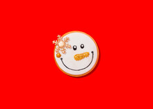 Snowman Shaped Christmas Cookie Against Vibrant Red Background