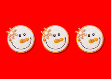 Three Snowman Shaped Christmas Cookies Against Vibrant Red Background