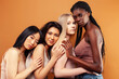 © iordani - young pretty asian, caucasian, african woman posing cheerful together on brown background, lifestyle diverse nationality people concept