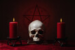 Pentagram symbol, human skull and candles. Black magic ritual or spell with occult and esoteric symbols. Red color...