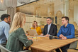 © Westend61 - Businessman having discussion with colleagues in meeting at board room