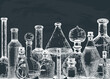 Hand-sketched glass equipment for perfumery and cosmetics making on chalkboard. Chemicals and alchemy glassware background. Perfume bottles, jars, flasks design in engraved style. Vintage drawing
