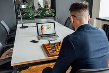 Businessman Learning Chess Online Through Laptop At Office