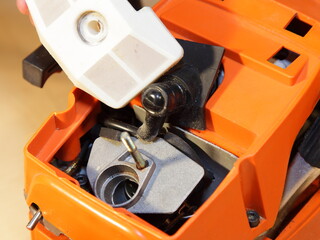 Poster - Chainsaw carburettor intake hole and air filter closeup under cap without cover - test, maintenance and service of power tool equipment before a work