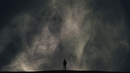 Wall Mural - the human silhouette standing on a dark cloudy background