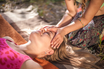 Wall Mural - Two women massage each other in the daylight.