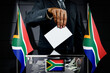 © PX Media - South Africa flags, hand dropping voting card - election concept - 3D illustration