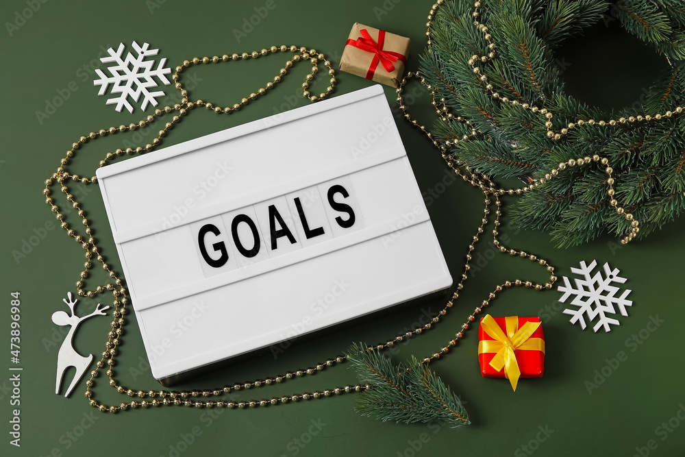 Christmas decor and word GOALS on green background