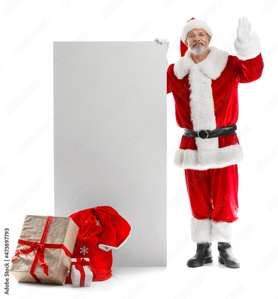 Santa Claus with big blank card and gift boxes waving hand on white background