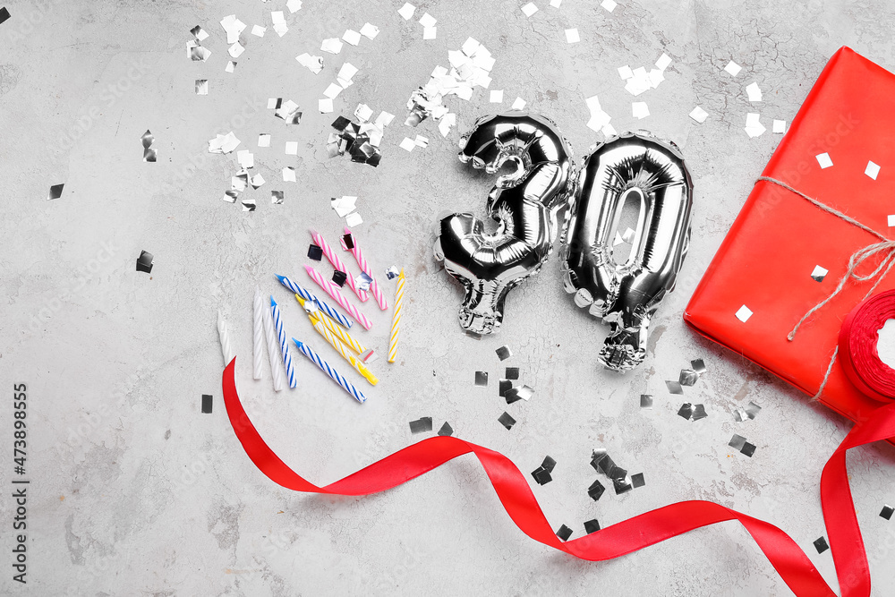 Birthday composition with silver balloons in shape of figure 30 on light background
