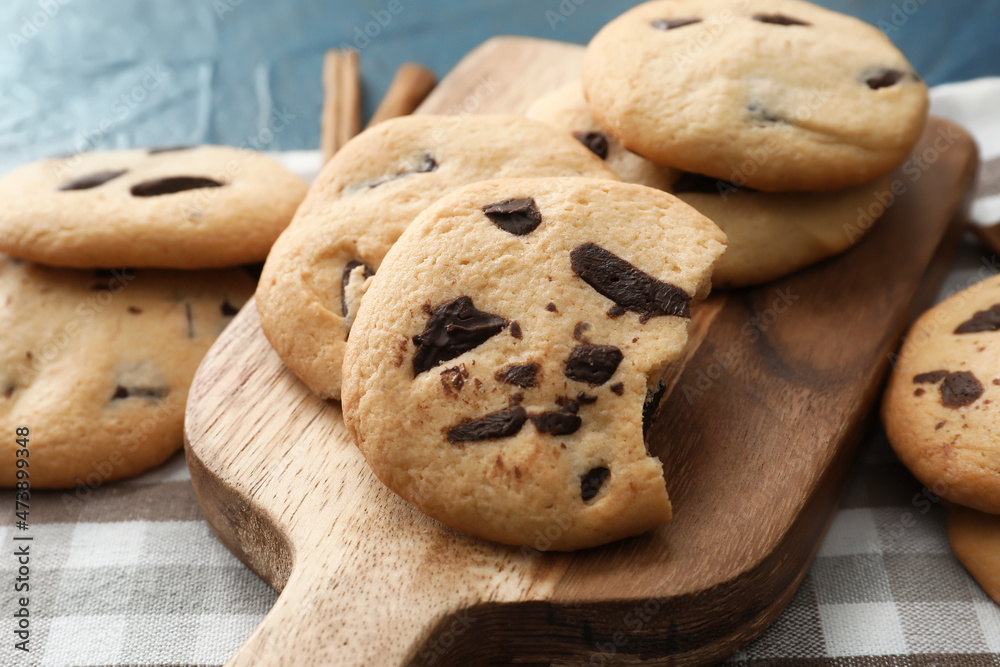 Board with tasty homemade cookies on table, closeup