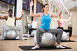 © JackF - Young sporty men and women doing pilates exercises with fitness ball at gym