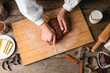 Woman preparing chocolate dough on wooden background