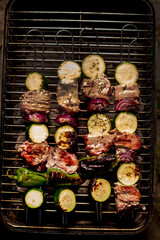 Poster - Close up of delicious pork on wooden skew with fresh vegetables