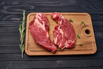 Wall Mural - meat steak wooden board and spices ingredients top view