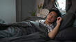 © Prathankarnpap - Asian man sleeping in his comfortable bed after tiring day.