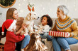 © JenkoAtaman - Happy kids getting dog for Christmas, multiethnic family with golden retriever celebrate New Year