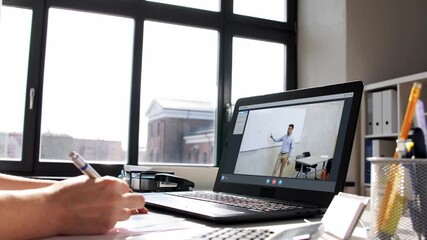 Wall Mural - remote job, technology and people concept - young businesswoman with laptop computer and papers working at home office and having video conference