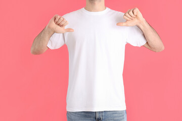 Wall Mural - Man in blank white t-shirt on pink background