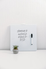 should would could did handwriting text quote on white board on table at home or office. inspiration