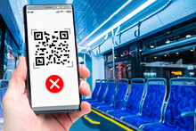 Prohibition Of Travel In Transport Without A QR Code. A Smartphone With A QR Code And A Red Forbidding Cross On The Screen. QR Code In Public Transport. Travel Only With A Vaccination Mark.