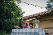 © Westend61 - Young couple wrapped in blanket sitting at table by motor home