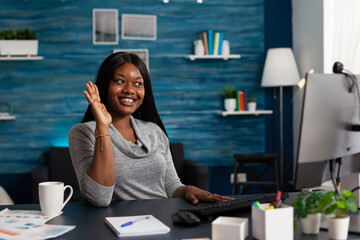 Poster - Adult talking on video call waving at computer webcam, doing business meeting and remote work at home. Modern woman using online conference on monitor with camera for communication.