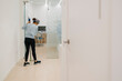 © Westend61 - Woman cleaning corridor floor in dental clinic