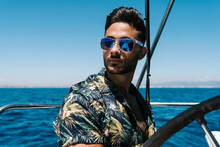 Handsome Young Man Wearing Sunglasses Traveling In Yacht