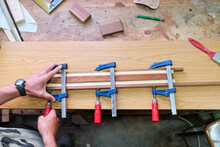 Crop Craftsman Clamping Wooden Sticks In Workshop