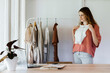 © Westend61 - Businesswoman showing crop top during video call through laptop at home