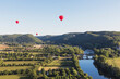 © Westend61 - Red hot air balloons flying against clear sky over Dordogne River
