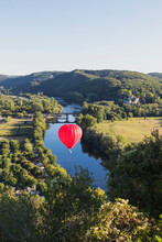 Red Hot Air Balloon Flying Over Dordogne River