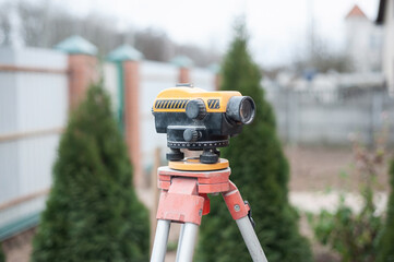 Surveying measuring equipment level transit on tripod at construction building area site