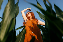 Smiling Young Woman Enjoying In Corn Field