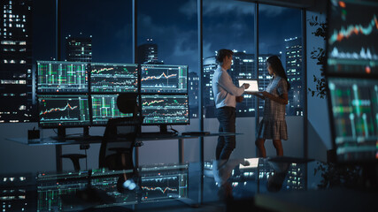 Poster - Financial Analyst Talking to Investment Banker in Late Evening at Work. Chatting About Real-Time Stock Chart Data on Tablet Computer. Businesspeople Have a Meeting in Broker Agency City Office.