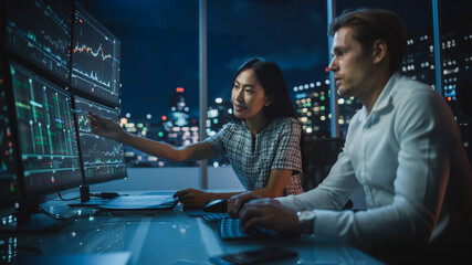 Poster - Financial Analyst Talking to Investment Banker in Late Evening at Work. Chatting About Real-Time Stock Chart Data on Tablet Computer. Businesspeople Have a Meeting in Broker Agency City Office.
