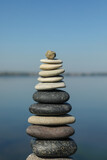 Fototapeta Desenie - Stack of stones near sea on sunny day. Harmony and balance concept