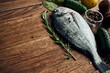 sea fish fresh ingredients lemon on wooden board