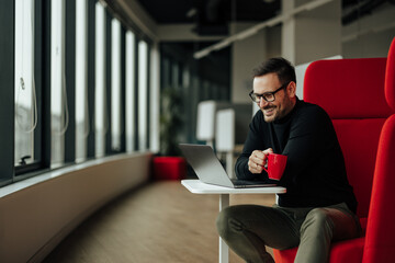 Smiling adult man, talking to his colleague, who is working overseas, online.