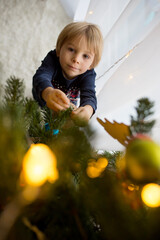 Poster - Cute toddler bchild, boy, decorating christmas tree