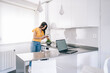 © Westend61 - Woman preparing salad while standing by kitchen counter at home