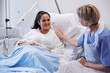 © Johnér - Female patient on hospital bed talking to nurse