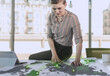 © Westend61 - Female professional looking at communication data on map at desk in office