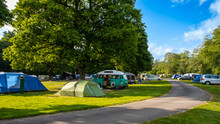 Camper Vans And Tents Pitched At A Camp Site During The Summer