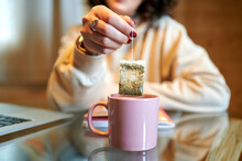 Mid Adult Woman Holding Tea Bag At Home