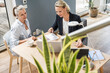 © Westend61 - Female professional doing paperwork with customer at office