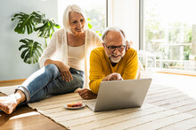 Mature Couple Using Laptop At Home